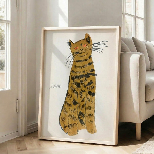 Colorful pop art wall print featuring numerous tabby cat images in vivid yellows and warm tones, punctuated by one striking blue feline portrait.