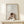 Minimalist framed artwork capturing the meditative essence of tea ritual, hands gently holding a cup against a peaceful cream and brown color scheme in Japandi design.