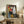 Cubist-inspired portrait with fragmented facial features in red, cream, and charcoal hues, displayed as a wall-mounted art print.