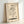 Wabi-sabi wall art depicting a single coffee cup releasing delicate steam, rendered in muted cream and black palette with understated Japanese aesthetic.