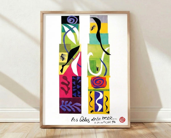 Abstract framed poster of vibrant sea creatures in bold cutout shapes, featuring blue, green, yellow, and red forms on white background in Matisse's modernist style.