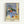 Framed modern art print of a carefully composed still life with a prominent blue ceramic vase surrounded by fresh fruit, displaying methodical brushwork in earthy and cool color tones.