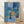 The Blue Window framed poster displaying an abstract landscape composition in cool blues, greens, and warm earth tones with minimalist geometric forms and a serene, contemplative mood.