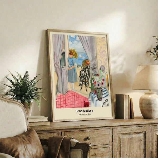 Framed modern art print of a sun-drenched Nice harbor, featuring stylized boats in bold blues and coral, reflecting Matisse's Art Nouveau aesthetic and leisurely atmosphere.