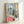 Framed art print showing sailboats and vessels in a bustling Nice waterfront, characterized by brilliant saturated colors and modernist composition.
