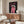 Vintage-inspired pop art poster of a woman's face with a haunting, dramatic expression rendered in hot pink, cream, and black tones; striking theatre art for any room.