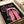 Contemporary retro-styled poster featuring a woman's portrait in bold pop art colors of hot pink, black, and cream with intense, theatrical mood and presence.