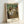 Framed impressionist artwork depicting graceful female dancers in a ballet studio, bathed in soft cream and ochre hues with contemplative mood.