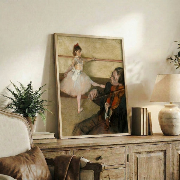 Framed fine art print of ballet dancers mid-lesson, captured in impressionist style with a serene palette of creams, grays, and soft blues suggesting peaceful concentration.