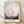 Abstract geometric framed poster featuring a pale pink circle with concentric spirals and heart form, soft blue and cream accents, and earthy tones in a Bauhaus minimalist style.
