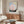 Abstract spiritual poster art featuring concentric geometric circles and spiral patterns in muted pink, blue, cream, and earthy tones.