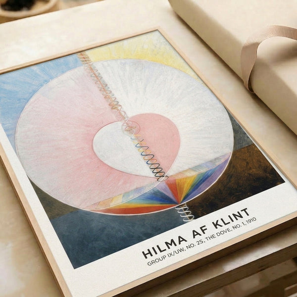 Framed minimalist geometric print with pale pink circular forms, blue accents, and cream background creating a spiritual abstract composition.
