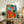 Framed modernist portrait showcasing a woman's thoughtful expression and distinctive green gaze against a harmonious blue and ochre color composition.