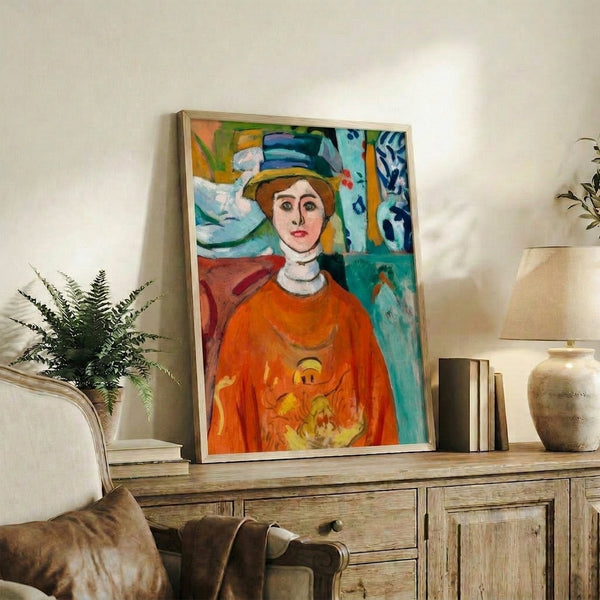 Framed modernist portrait showcasing a woman's thoughtful expression and distinctive green gaze against a harmonious blue and ochre color composition.