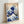 Timeless ukiyo-e masterpiece showing an enormous wave threatening a tiny vessel against a serene mountain landscape, rendered in indigo and cream tones.