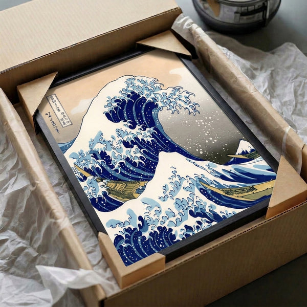 Vintage Japanese woodblock masterpiece depicting a powerful wave in indigo tones with pale sky and distant mountain, presented as a framed poster print.