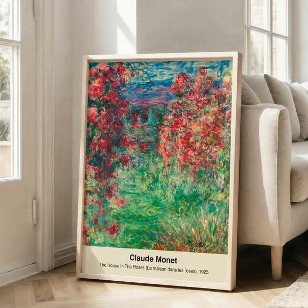Framed garden art print showing a residence enveloped by blooming roses in romantic impressionist style with luminous pale blue and white accents.