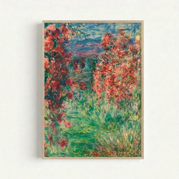 Claude Monet's The House In The Roses displayed as a framed wall poster, showcasing delicate pink and white florals enveloping a serene country house in muted, dreamy tones.