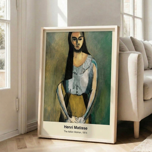 Minimalist woman's portrait in cream, black, and muted ochre hanging framed on a wall, evoking an introspective, austere mood through simplified form.