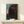 Framed print of an affectionate couple kissing, painted in a loose expressionist manner with soft, blended warm and cool color palette.