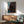 Romantic framed artwork depicting a passionate embrace rendered in expressionist style with soft, flowing forms and warm earthy hues.