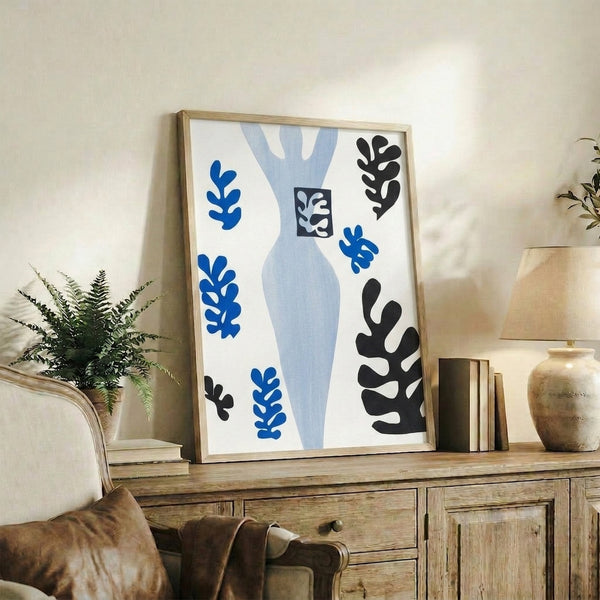 Mid-century modern art print showcasing bold abstract forms in ochre, rust, and cream, inspired by cut-paper composition methods and displayed as framed wall art.