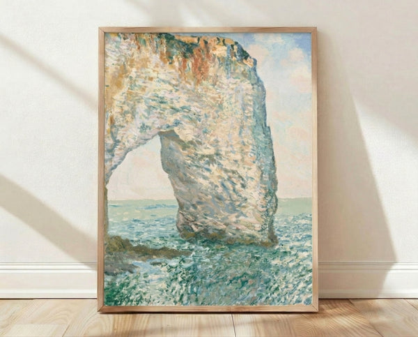 Impressionist seascape painting of the Manneporte rock arch near Étretat with soft blue and golden tones, framed poster on wall.