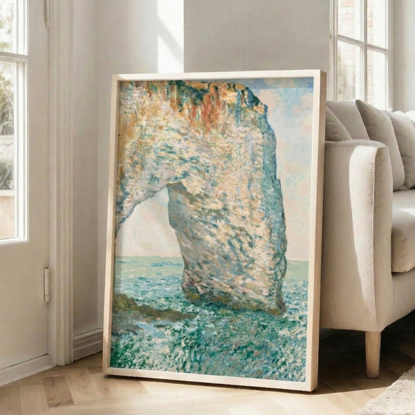 Impressionist beach landscape showing the dramatic Manneporte natural arch glowing in soft golden and blue light, displayed as a framed poster.
