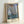 Serene impressionist seascape with a majestic seaside rock formation and arch, painted in soft grays, ochres, and blues creating a contemplative mood.