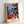 Bold pop art portrait of comedic legends rendered in electric blues and vivid reds with high-contrast colors typical of contemporary pop art printmaking.
