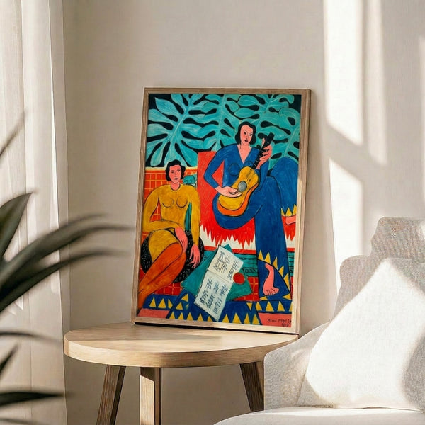 Framed abstract artwork depicting people in motion with musical instruments, composed of bold color blocks and organic shapes that convey rhythm, joy, and creative expression.