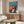 Colorful modern print showing stylized figures celebrating music through dance and performance, featuring a sophisticated palette of blues, oranges, and earth tones in a joyful composition.