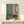Framed art print of a figure playing piano in a tranquil interior, combining warm yellows and soft greens in a semi-abstract composition.