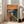 Wall-mounted poster reproduction of the famous expressionist painting with its characteristic swirling sky, bridge railing, and haunting central figure in muted earth and intense blues.