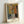 Abstract figure of a guitarist in minimalist line art, dominated by ochre and blue tones against cream background; framed wall art.