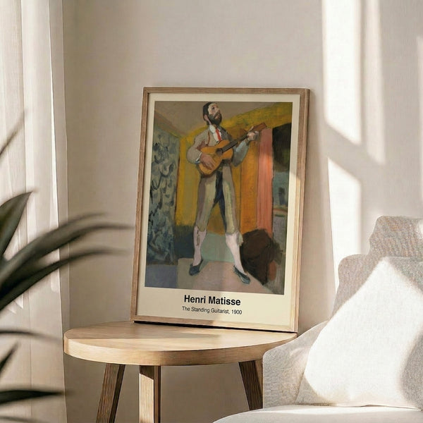 Modernist depiction of a male figure with guitar in expressive black linework, ochre and blue accents; artistic framed wall art.