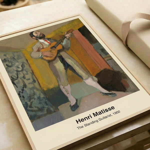 Line-drawn guitarist in contemplative pose, rendered in ochre, blue, and black with sophisticated minimalist style; framed contemporary poster.