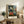Contemporary art poster of a creative workspace with model and easel, rendered in soft impressionistic blues, greens, and earth tones, evoking contemplative artistic atmosphere.