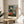 Impressionist-style studio artwork featuring chair, canvas, and figure near a window overlooking the Seine at Quai St Michel, in muted ochre and blue palette as framed wall art.