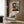 Modern poster of an intimate artist's studio interior with easel and model, composed in soft impressionistic tones of blue, green, and warm ochre, evoking peaceful creative space.