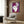 Modern cutout lithograph poster of a performer figure in playful geometric shapes with a lively color scheme, framed as contemporary wall art.