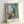 Framed Matisse poster depicting a sunlit Mediterranean terrace with harbor and sailboats, painted in warm yellows, deep blues, and earthy terracotta hues.