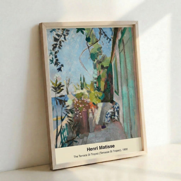 Framed Matisse poster depicting a sunlit Mediterranean terrace with harbor and sailboats, painted in warm yellows, deep blues, and earthy terracotta hues.
