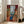 Wall art print in soft tertiary colors—ochre, blue, and cream—presenting a figure in a light-filled room with simplified forms and decorative patterning reminiscent of Matisse's Nice period.