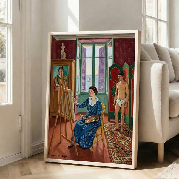 Wall art print in soft tertiary colors—ochre, blue, and cream—presenting a figure in a light-filled room with simplified forms and decorative patterning reminiscent of Matisse's Nice period.