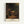 Framed impressionist poster of Rembrandt's The Visitation showing two women in fabric garments meeting in candlelit interior space with contemplative, intimate mood.