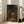 Classic impressionist interpretation of The Visitation featuring figures illuminated by soft golden light against deep shadows and ochre-toned interior setting.