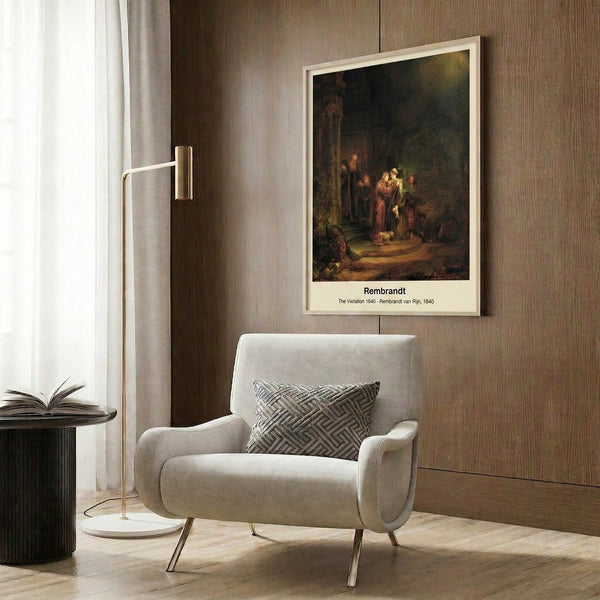 Framed art print of Rembrandt's iconic The Visitation depicting figures in period fabric amid warm spiritual light, rendered in ochre, shadow, and gold tones.
