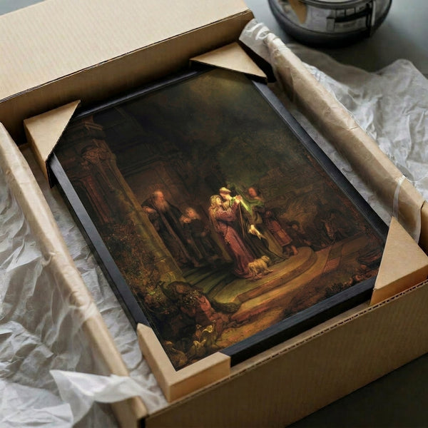 Framed reproduction of Rembrandt's The Visitation, a baroque masterpiece depicting a biblical encounter with luminous golden tones and intricate detail work.
