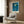 Contemporary abstract poster of an interior window scene in cool blues and whites, framed and mounted as bedroom or living room decor.